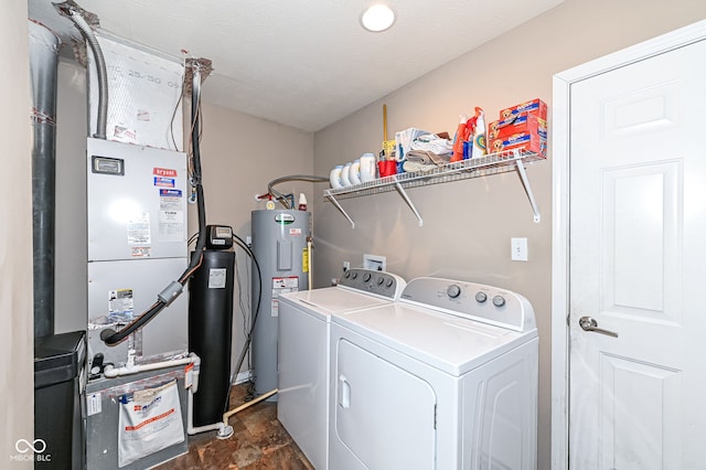 laundry area featuring laundry area, electric water heater, a textured ceiling, and separate washer and dryer