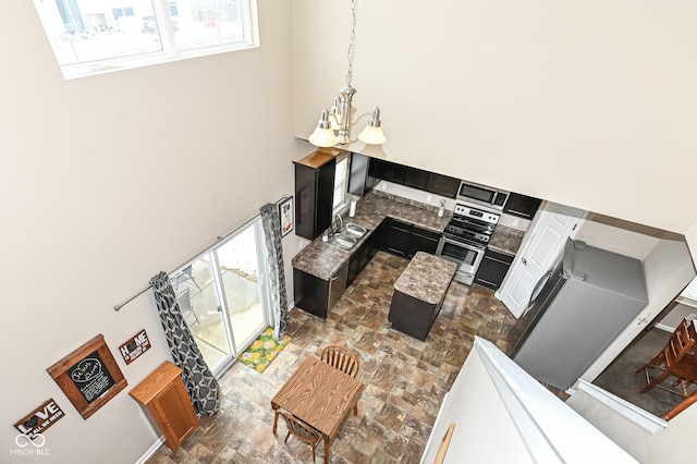 living room with a chandelier and a towering ceiling