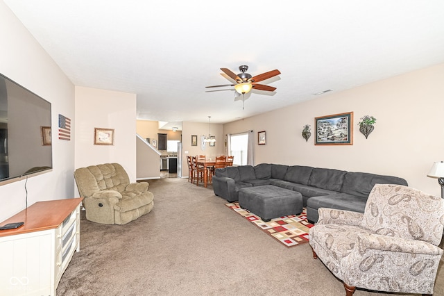 carpeted living area featuring a ceiling fan and visible vents