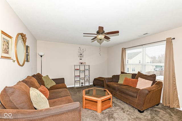 living area with baseboards, visible vents, a ceiling fan, light colored carpet, and a textured ceiling