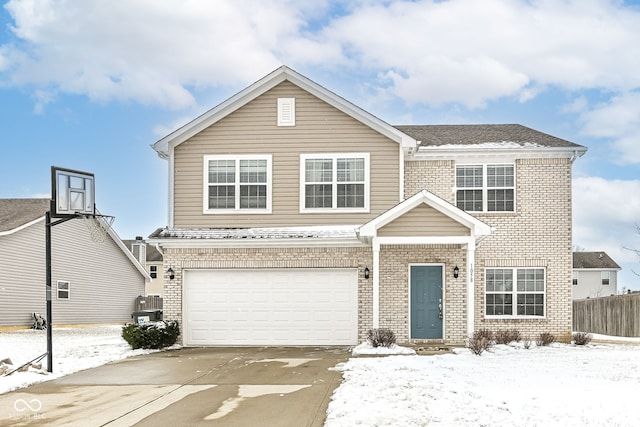 traditional-style home featuring a garage, concrete driveway, and brick siding