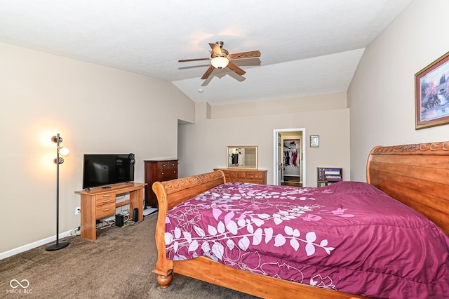 carpeted bedroom featuring a walk in closet, a closet, vaulted ceiling, ceiling fan, and baseboards