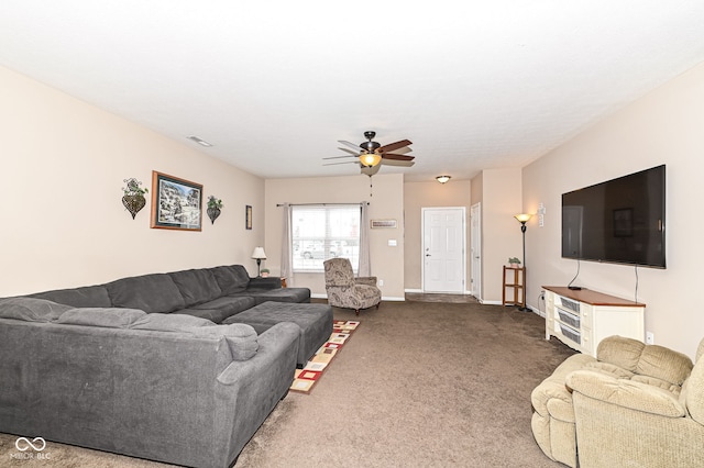 living room with carpet floors, visible vents, baseboards, and a ceiling fan