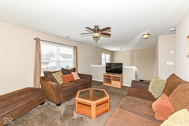 living area featuring visible vents, carpet flooring, ceiling fan, a textured ceiling, and baseboards