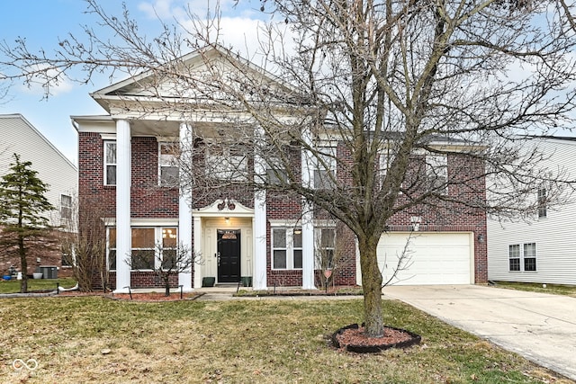 neoclassical home featuring a garage and a front lawn