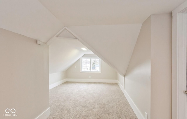 additional living space featuring lofted ceiling and light carpet