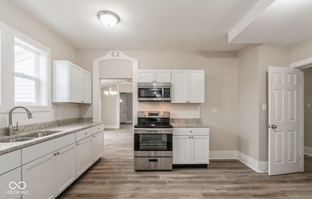 kitchen featuring appliances with stainless steel finishes, sink, and white cabinets