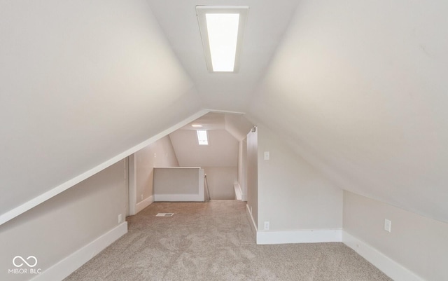 additional living space featuring lofted ceiling and light colored carpet