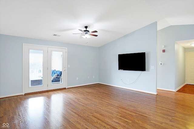 unfurnished living room with baseboards, visible vents, ceiling fan, wood finished floors, and vaulted ceiling