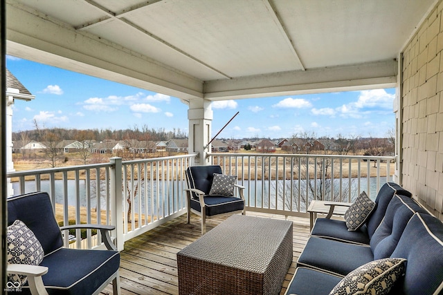 wooden deck featuring a residential view and a water view