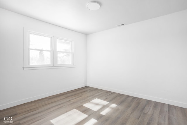 spare room with light hardwood / wood-style floors