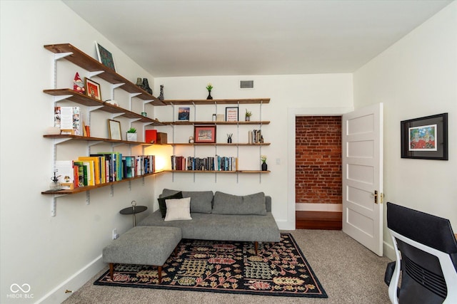 sitting room featuring visible vents, light carpet, and baseboards