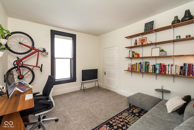 carpeted office space featuring baseboards