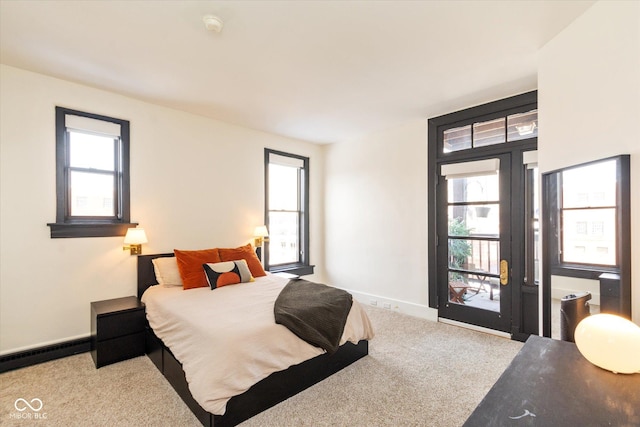 bedroom with baseboards, multiple windows, and light colored carpet