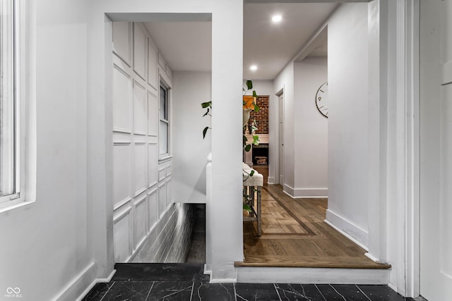 hallway with dark parquet floors