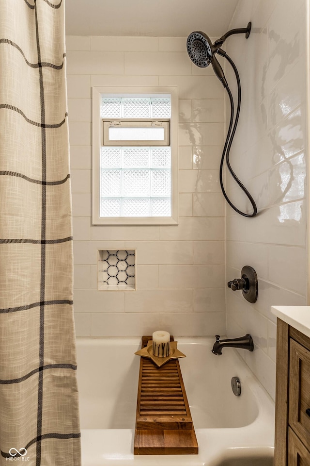 bathroom featuring vanity and shower / bathtub combination with curtain