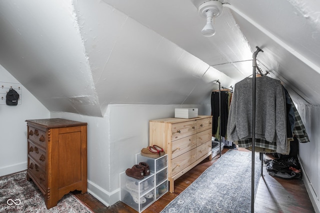 bonus room featuring dark wood-style floors, lofted ceiling, and baseboards