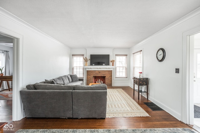 living area featuring dark wood-style floors, a fireplace, visible vents, ornamental molding, and baseboards