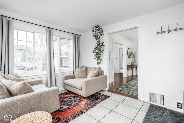 living room featuring light tile patterned floors and visible vents