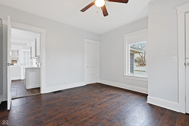 unfurnished bedroom with ceiling fan and dark hardwood / wood-style flooring