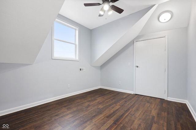 additional living space with vaulted ceiling, dark wood-type flooring, and ceiling fan