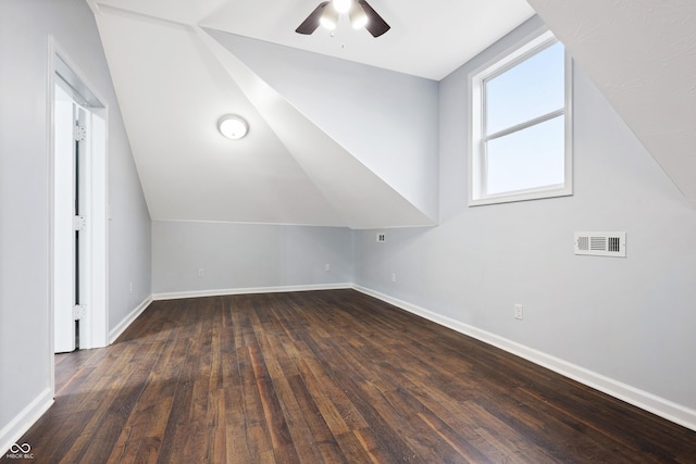 additional living space with ceiling fan, lofted ceiling, and dark hardwood / wood-style flooring