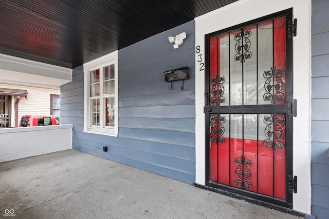 view of exterior entry featuring a porch