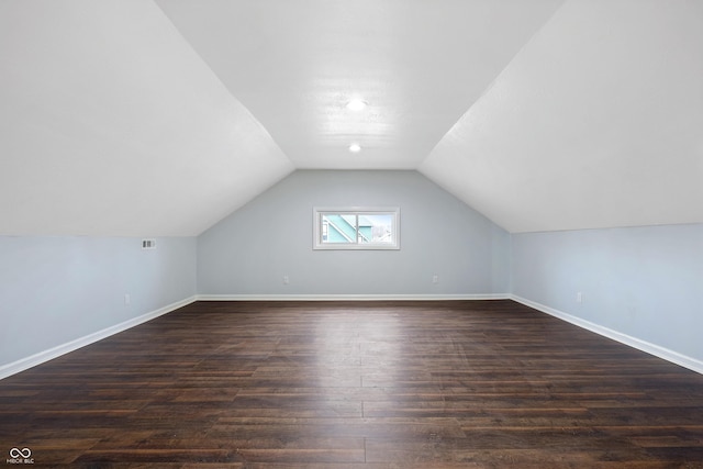 additional living space featuring lofted ceiling and dark hardwood / wood-style floors