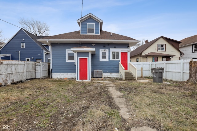 back of property featuring a yard and central air condition unit