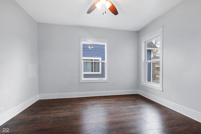 spare room featuring dark wood-type flooring and ceiling fan