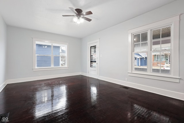 spare room with ceiling fan and dark hardwood / wood-style flooring