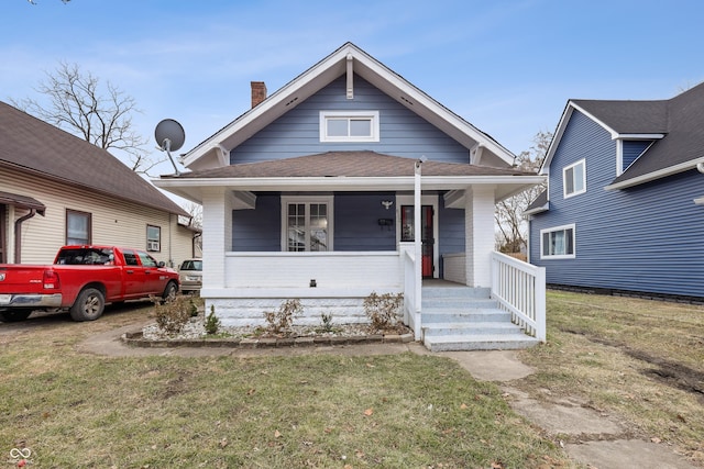 bungalow-style house featuring a front yard and covered porch