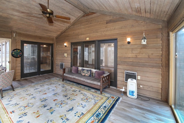 interior space featuring lofted ceiling with beams, wood ceiling, and a ceiling fan