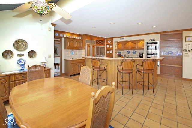 dining space with crown molding, recessed lighting, ceiling fan, and light tile patterned floors