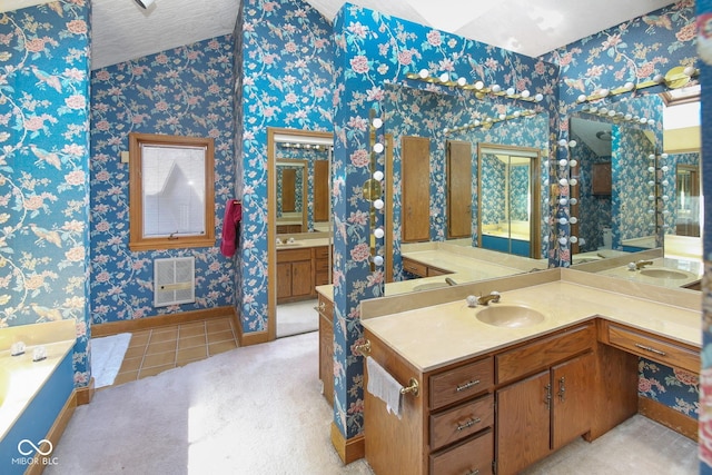 bathroom with wallpapered walls, a garden tub, vanity, and heating unit