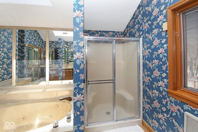 bathroom with a shower stall, a whirlpool tub, and wallpapered walls