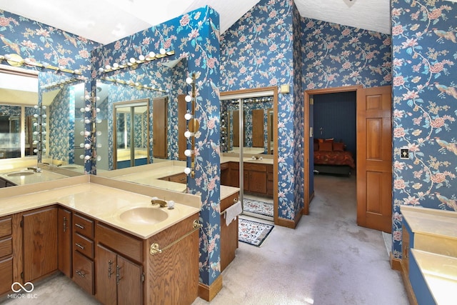 full bathroom with vanity and wallpapered walls