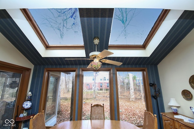 dining room featuring a skylight