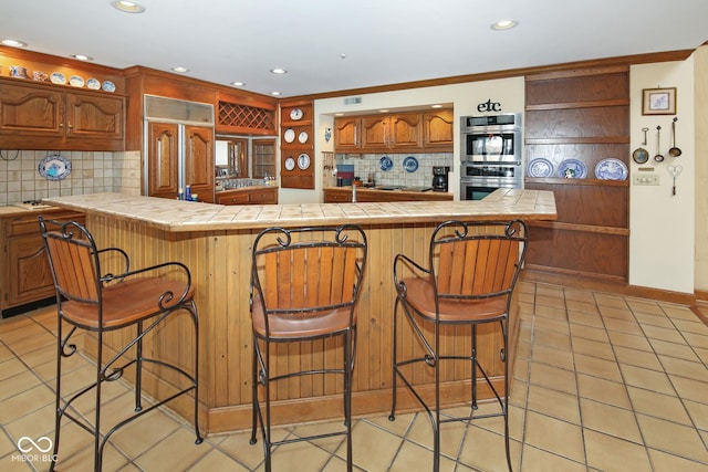 kitchen featuring tile countertops, paneled built in refrigerator, open shelves, and stainless steel double oven