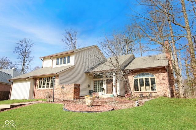 traditional-style house featuring a front yard, a chimney, and brick siding