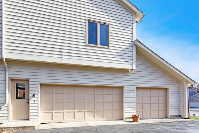 view of side of property featuring an attached garage