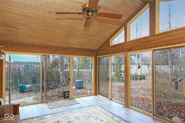 unfurnished sunroom featuring lofted ceiling, wood ceiling, and ceiling fan