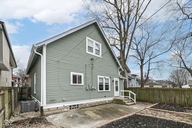 rear view of house featuring central AC