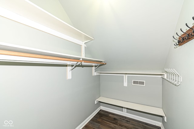 walk in closet with dark wood-type flooring