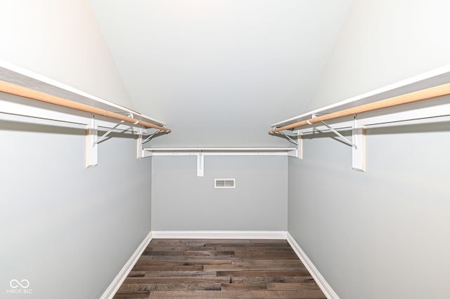 spacious closet featuring dark hardwood / wood-style flooring