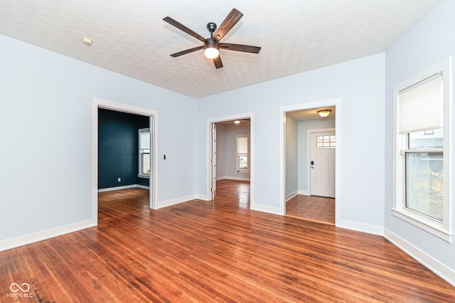 unfurnished room with ceiling fan, hardwood / wood-style flooring, and a textured ceiling