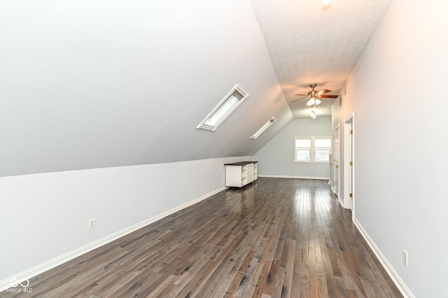 additional living space with vaulted ceiling, dark wood-type flooring, and ceiling fan