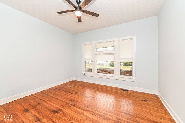 unfurnished room with hardwood / wood-style flooring and ceiling fan