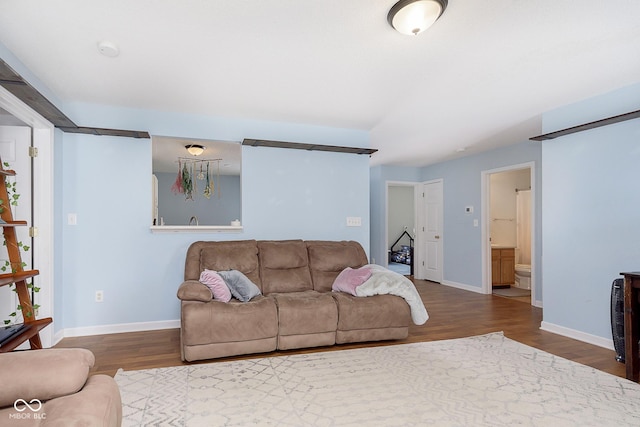 living area with baseboards and wood finished floors