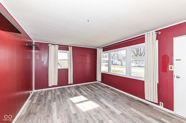 unfurnished room with hardwood / wood-style flooring